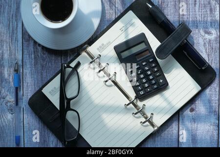 high angle view of open diary, and calculator on table  Stock Photo