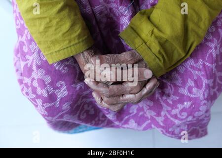 Hands of an old woman folded one over the other. Stock Photo