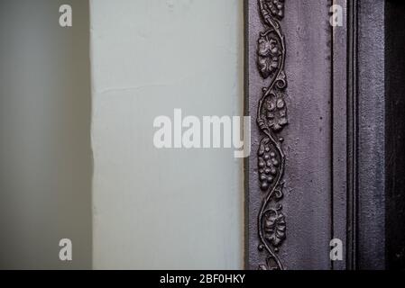 Cast iron fire place surround detail featuring a grapevine. Close-up abstract background Stock Photo