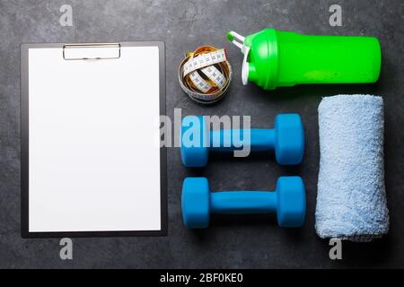 Fitness Equipment On A Stone Background. Top View Flat Lay With Copy Space  For Workout Plan Stock Photo, Picture and Royalty Free Image. Image  141454172.