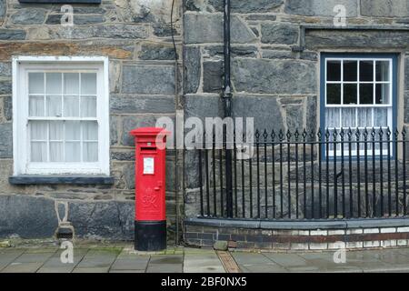 Traditional British red pillar box on a street in Blaenau Ffestiniog in Wales Stock Photo