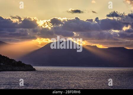 Sunset over Tyrrhenian Sea seen from Zafferano cape near Santa Flavia on Sicily Island in Italy, view with Pellegrino mountain on background Stock Photo