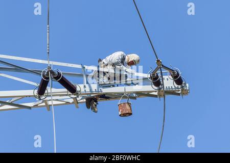 Painter on high voltage pylon, Baden-Wuertemberg, Germany Stock Photo