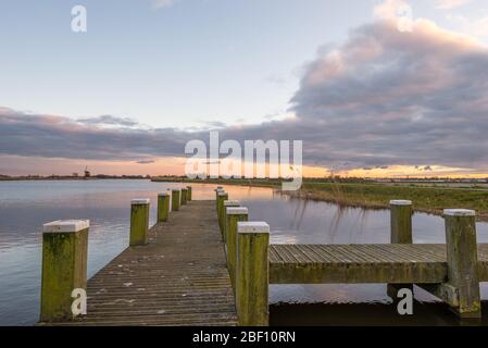 Scenic view of a pier at lake 'Rottemeren' in Holland with beautiful evening sky. Stock Photo