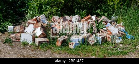 Group of Old Damaged Destroyed Thrown Away Red Bricks Stock Photo