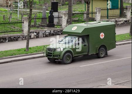 RIVNE, UKRAINE - APRIL 14, 2020. Mmilitary ambulance in the city Stock Photo