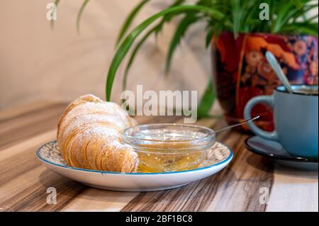 Plate with tasty freshly baked croissant on table. Delicious breakfast with fresh croissants Stock Photo