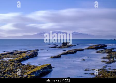 Long exposed image of Arran mountains taken on a bittery cold day in january. The image has a soft etherial look. Stock Photo