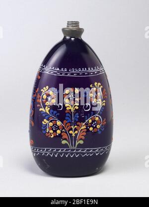 Bottle. Tear-drop shaped glass in deep purple with painted decoration. Stock Photo