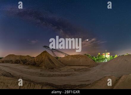 Conveyor bridge at night and the milky way, watching the stars at a construction area. Stock Photo