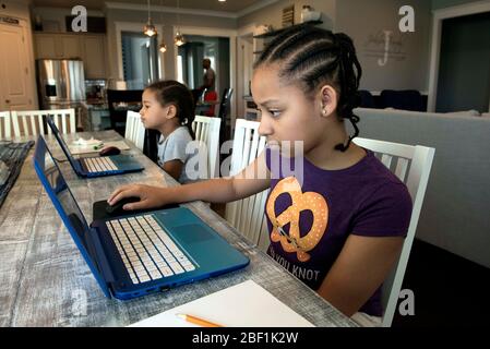 Canton, GA, USA. 16th Apr, 2020. Morgan and Logan Johnson as they work on their school assignments online at home. Schools throughout Georgia are closed for the rest of the academic year because of the COVID-19 pandemic. Credit: Robin Rayne/ZUMA Wire/Ģ����ý Live News Stock Photo