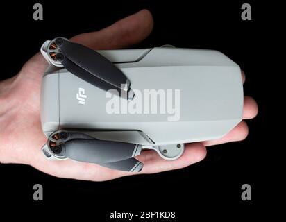 Teplyk, Vinnytsia, Ukraine - April 16, 2020. DJI Mavic Mini compared to the hand of an adult man. Quadcopter in hand. Stock Photo