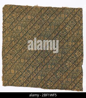 Fragment. Blue-green embroidery on an ivory ground showing diagonal floral bands. Type of material used for women's pants. Stock Photo