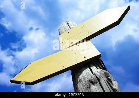 Empty wooden signpost with two arrows Stock Photo