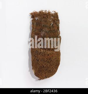 Bag. Small bag of open knotted net in cotton, filled with skeins of colored wools for weaving. Stock Photo