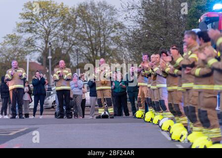 Firefighters clapping at Clap for Carers at 8pm outside Southend Hospital in evening to thank NHS and key workers during the COVID-19 Coronavirus Stock Photo