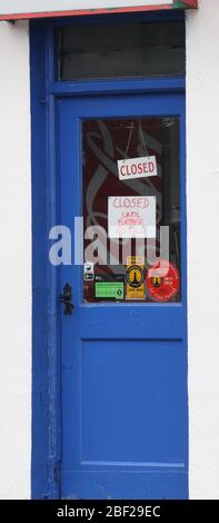 Impact of Covid-19 Northern Ireland, Closed until further notice sign on door of village chip shop in March 2020. Stock Photo