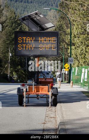 NORTH VANCOUVER, BC, CANADA - APR 11, 2020: A electronic roadside sign displaying information related to the Covid 19 pandemic. Stock Photo