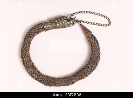 Bracelet. Bracelet of silver filigree with clasp representing a snake's head. Stock Photo