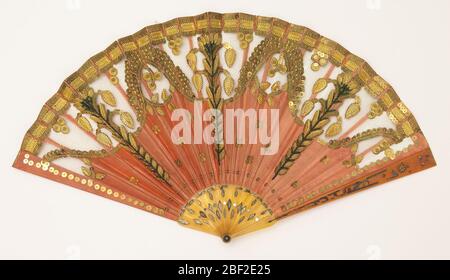 Pleated fan. Pleated fan, silk leaf with silk net, embroidered with metallic spangles and stamped metal pieces in a floral pattern, sticks of incised horn with applied metallic foil. Coral-colored silk with classical ornament in gold metallic. Stock Photo