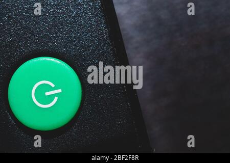 Green power button on the remote control close up Stock Photo