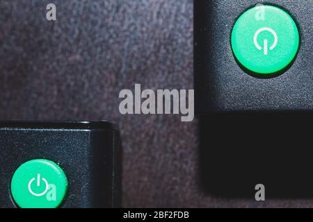 Green power buttons on the remote control close up Stock Photo