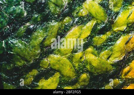 Green material close up background. creased cloth abstract texture Stock Photo