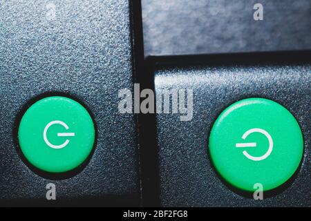 Green power buttons on the remote control close up Stock Photo