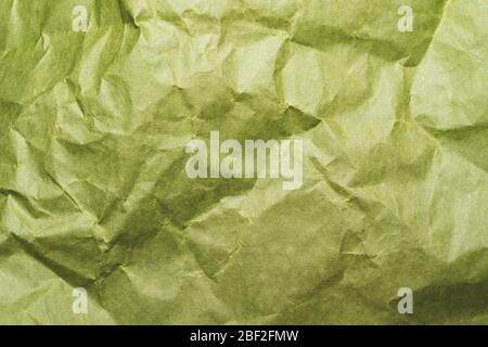 Crumpled green paper close up. creased kraft paper material Stock Photo