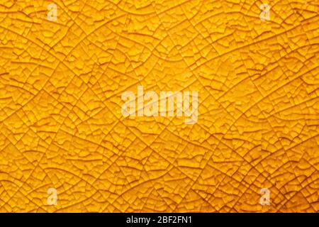 Cracked ceramic texture close up. fractured glass background. abstract yellow surface. broken mosaic glass macro backdrop Stock Photo