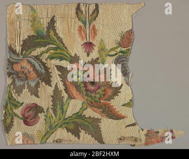 Fragment. Fragment with a design of large flowers, leaves and stems embroidered in shades of red, purple, blue, and green with metallic thread on a ground of cream-colored silk woven in a horizontal chevron pattern. Stock Photo