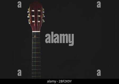 Guitar headstock on black background. acoustic musical instrument. copy space Stock Photo