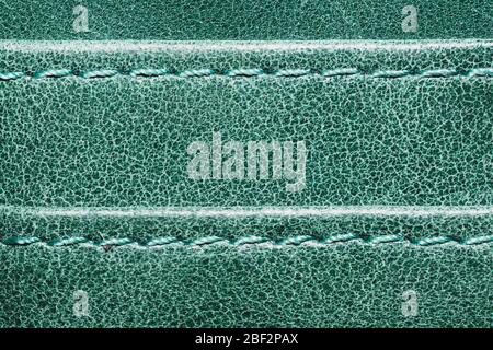 Green leather texture with stitches. material with seams. emerald color background Stock Photo