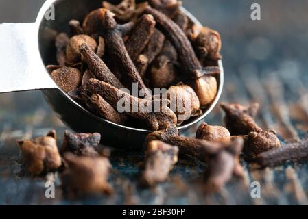 Whole Cloves Spilled from a Teaspoon Stock Photo