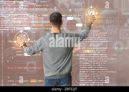 Male programmer using virtual screen, back view Stock Photo