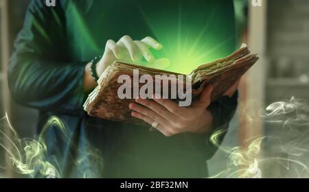 Male magician with spell book, closeup Stock Photo