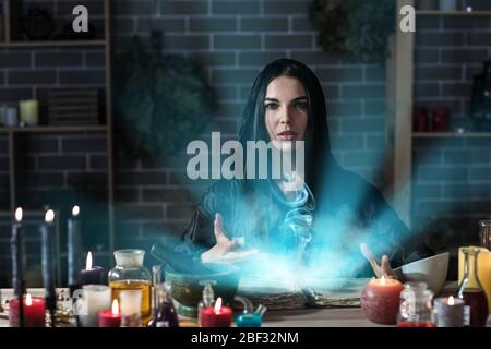 Female alchemist making elixir in laboratory Stock Photo