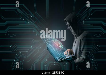 Professional hacker with laptop on dark background Stock Photo
