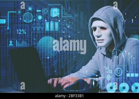 Professional hacker using laptop in dark room Stock Photo