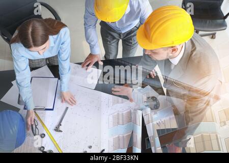 Double exposure of modern building and group of architects working in office Stock Photo