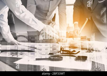 Double exposure of modern building and group of architects working in office Stock Photo