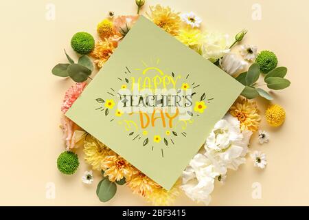 Card with text HAPPY TEACHER'S DAY and beautiful flowers on color background Stock Photo