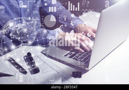 Businesswoman working on laptop late in evening Stock Photo
