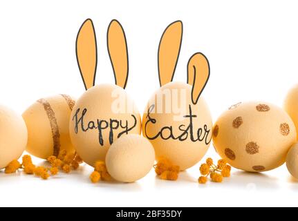 Beautiful Easter eggs with drawn bunny ears on white background Stock Photo