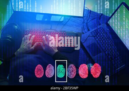 Professional hacker using computer in dark room Stock Photo