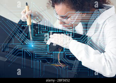Electronic technician working in service center Stock Photo