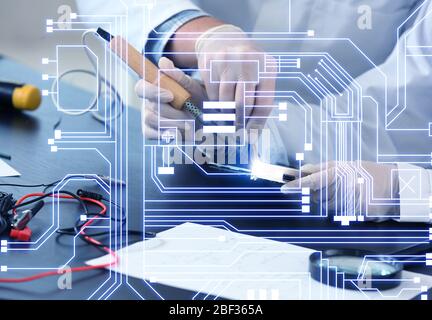 Electronic technicians working in service center Stock Photo