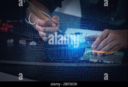 Electronic technician working in service center Stock Photo