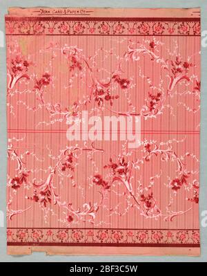 Sidewall. Matching sidewall and border. Wallpaper contains floral bouquets and scrolling foliate scrolls.Printed in red and white on mica-striped background. Maroon, rose and white floral scrollwork on pink ground. Border is printed two across the width. Stock Photo