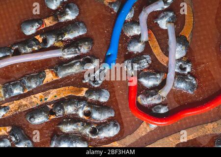 Handmade circuit board with connections and traces. colorful wires. industrial background Stock Photo